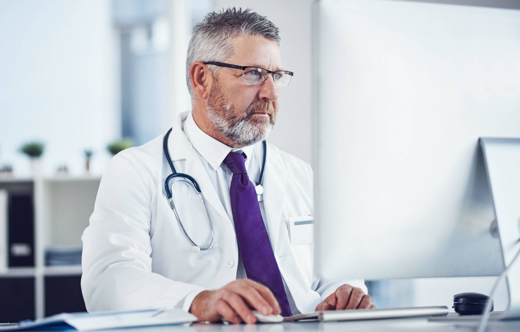 physician sitting at computer