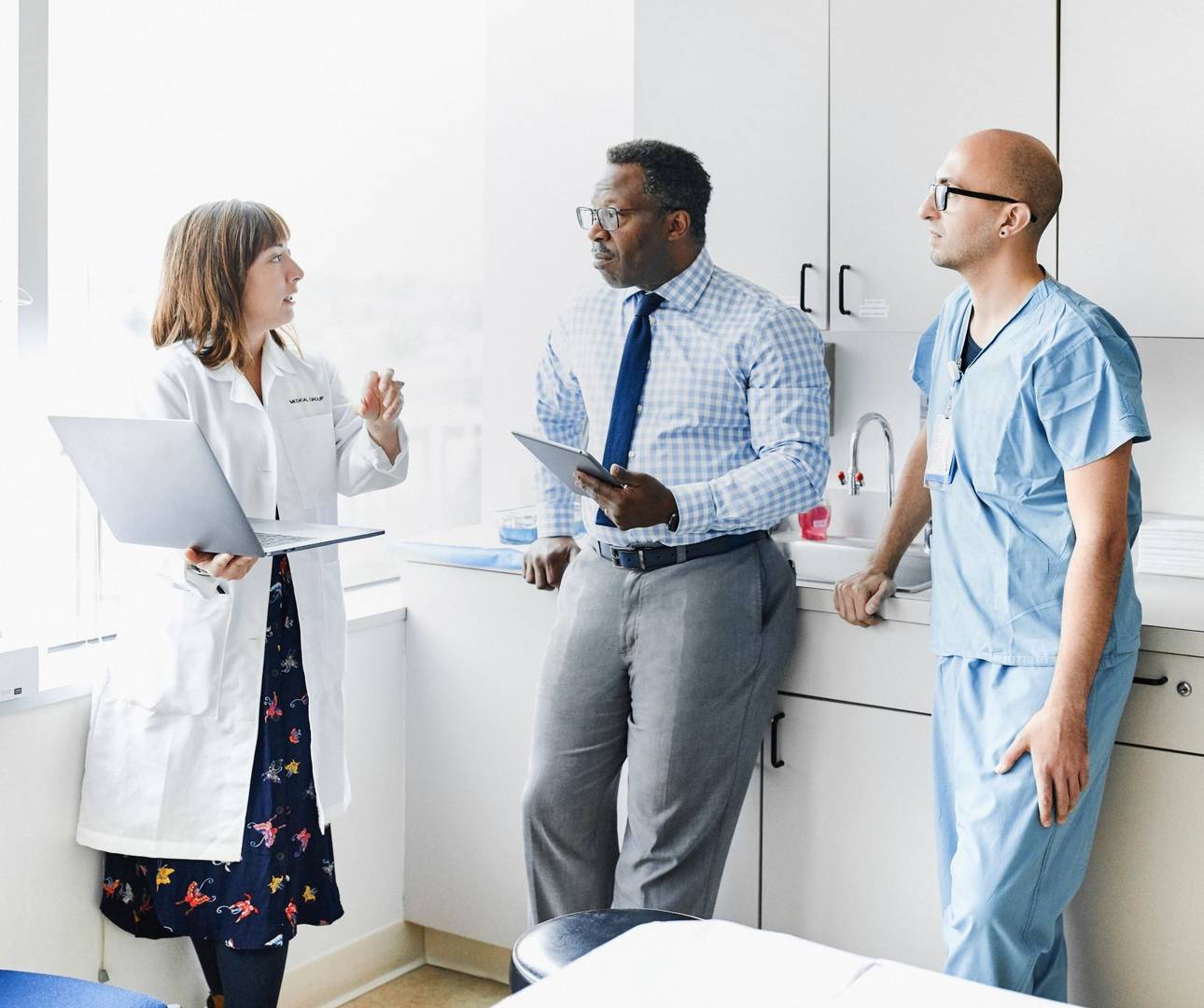Physician meeting with staff