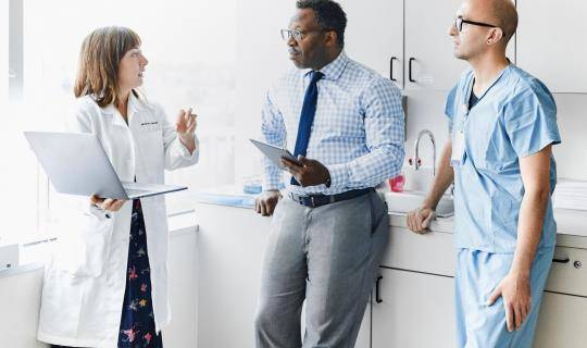 Physician meeting with staff