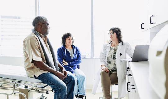 Elderly Black man with community oncology doctor