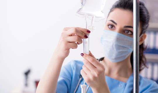 Nurse prepping infusion